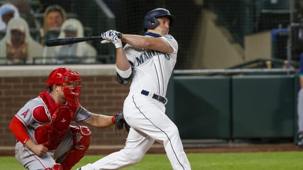 Aug 5, 2020; Seattle, Washington, USA; Seattle Mariners third baseman Kyle Seager (15) hits a single against the Los Angeles Angels during the seventh inning at T-Mobile Park. Mandatory Credit: Joe Nicholson-USA TODAY Sports
